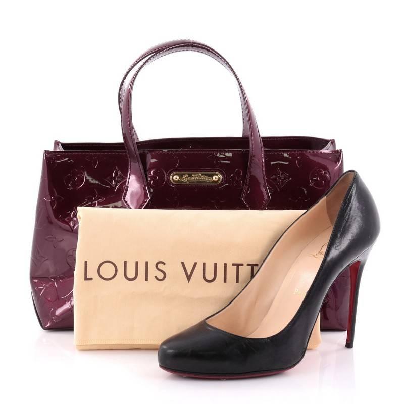 This authentic Louis Vuitton Wilshire Handbag Monogram Vernis PM combines elegance and sophistication ideal for day to day excursions. Crafted in rouge fauviste monogram vernis leather, this simple shopper tote features dual-flat handles, a sturdy