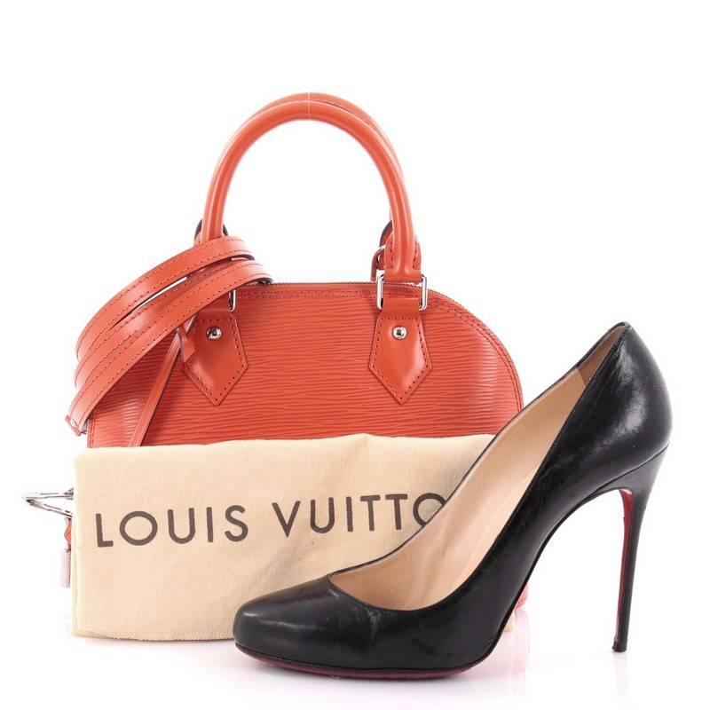 This authentic Louis Vuitton Alma Handbag Epi Leather BB is a chic and sophisticated bag perfect for your everyday use. Constructed with Louis Vuitton's signature sturdy orange epi leather, this petite dome-like bag features a sturdy base,