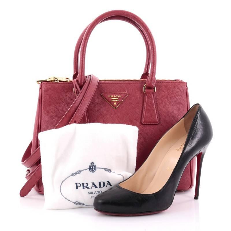This authentic Prada Double Zip Lux Tote Saffiano Leather Small is the perfect bag to complete any outfit. Crafted from red saffiano leather, this boxy tote features side snap buttons, raised Prada logo, dual-rolled leather handles and gold-tone