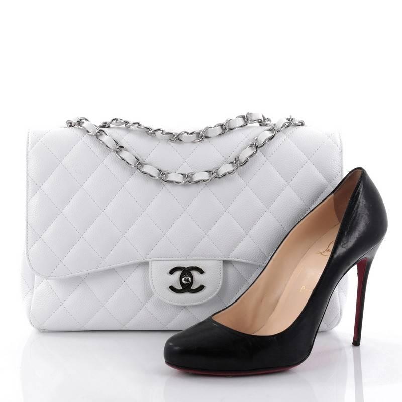 This authentic Chanel Classic Double Flap Bag Quilted Caviar Jumbo exudes a classic yet easy style made for the modern woman. Crafted from white caviar leather, this elegant flap features Chanel's signature diamond quilted design, woven-in leather