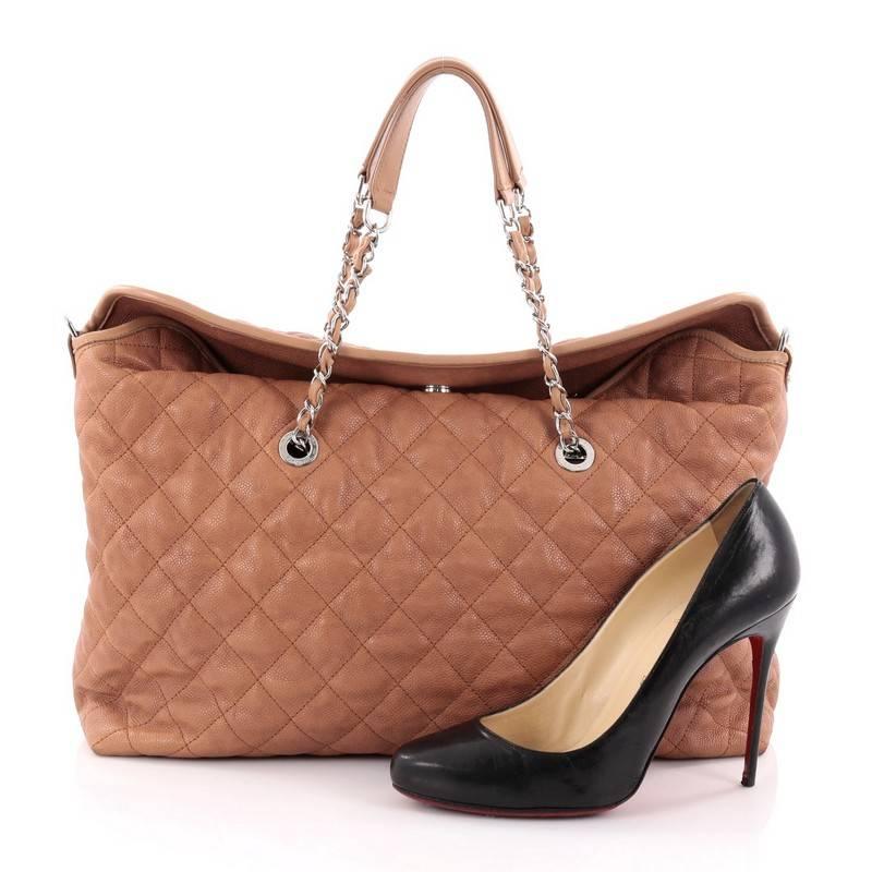 This authentic Chanel French Riviera Fold Tote Quilted Caviar Large from the brand's Cruise 2012 Collection is a relaxed bag with refined design perfect for your casual looks. Crafted from light brown quilted caviar leather, this chic bag dual