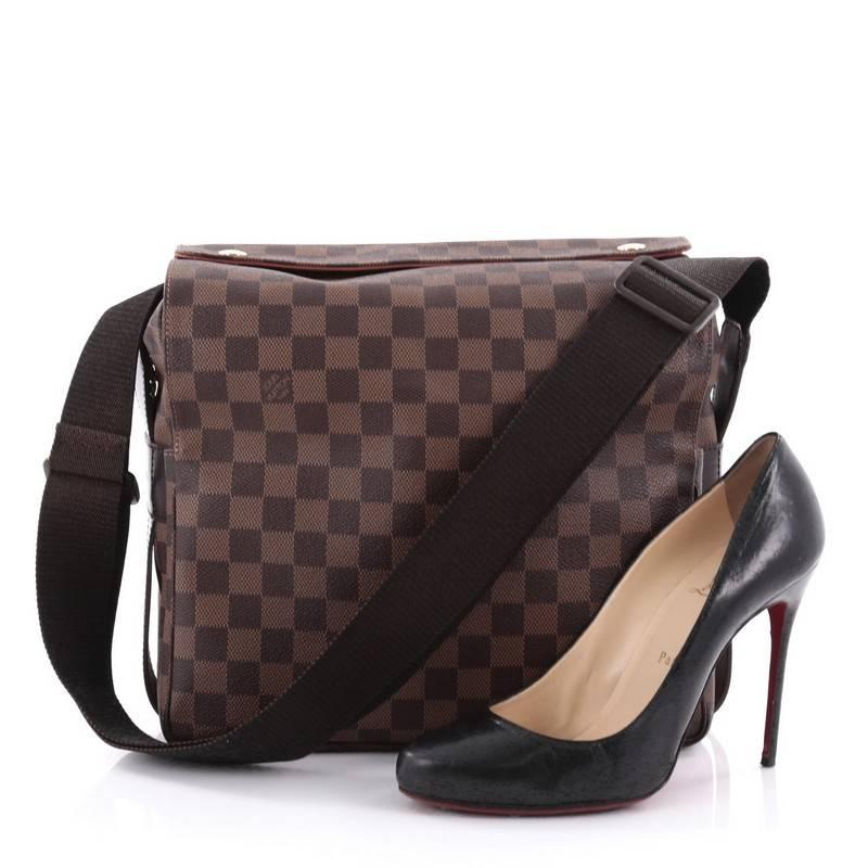 This authentic Louis Vuitton Naviglio Handbag Damier is perfect for the style conscious man or woman on the go. Crafted from damier ebene coated canvas, this elegant bag features wide canvas adjustable strap, large dual flap design and gold-tone
