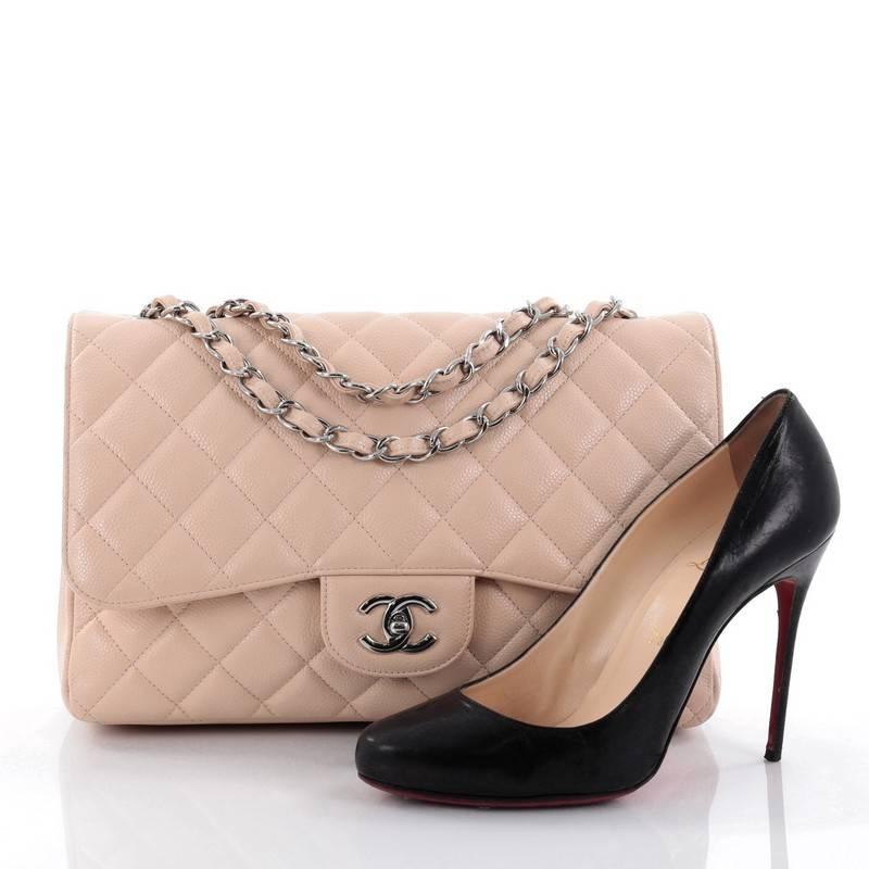This authentic Chanel Classic Single Flap Bag Quilted Caviar Jumbo is a timeless essential for any modern woman. Crafted in light nude quilted caviar leather, this classic flap features woven-in leather chain strap, exterior back pocket, CC