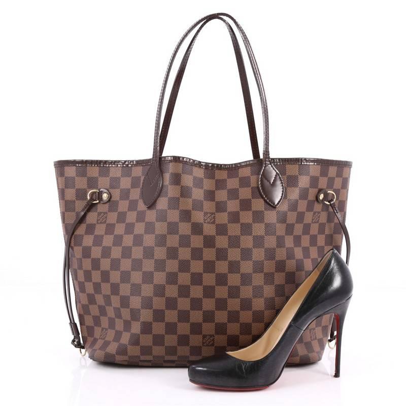 This authentic Louis Vuitton Neverfull Tote Damier MM is a popular and practical oversized tote beloved by many. Constructed with Louis Vuitton's signature damier ebene coated canvas, this tote features dual slim vachetta handles, side laces can be