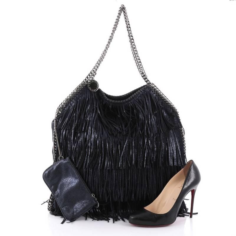 This authentic Stella McCartney Falabella Fringe Tote Faux Suede Large is perfect for casual day-to-day excursions with an edgy twist. Crafted in navy blue faux metallic suede, this luxurious tote features slinky chain handles, signature curb chain