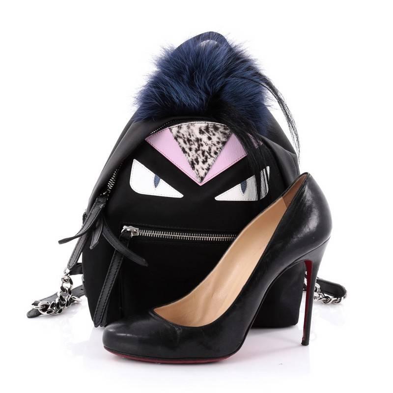 This authentic Fendi Monster Backpack Nylon with Leather and Fur Mini balances a luxurious, playful style made for on-the-go fashionistas. Crafted from black nylon, this backpack features Fendi's popular monster design in leather and fur accents, a