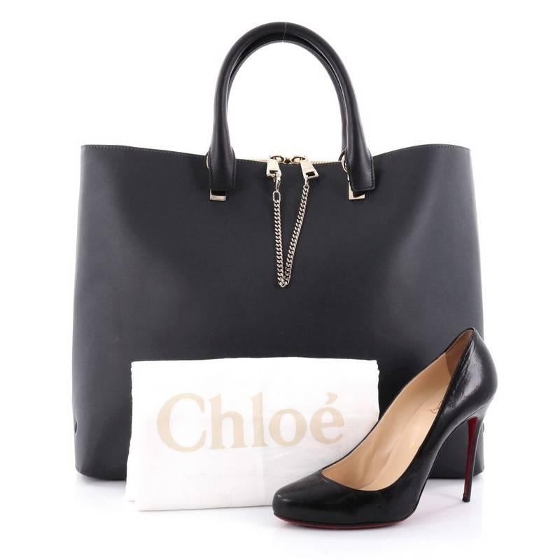 This authentic Chloe Baylee Shopper Leather Large is simple and classic in design perfect for everyday look. Crafted in light grey and blue leather, this bag features dual-rolled leather handles and gold tone-hardware accents. It opens to a spacious