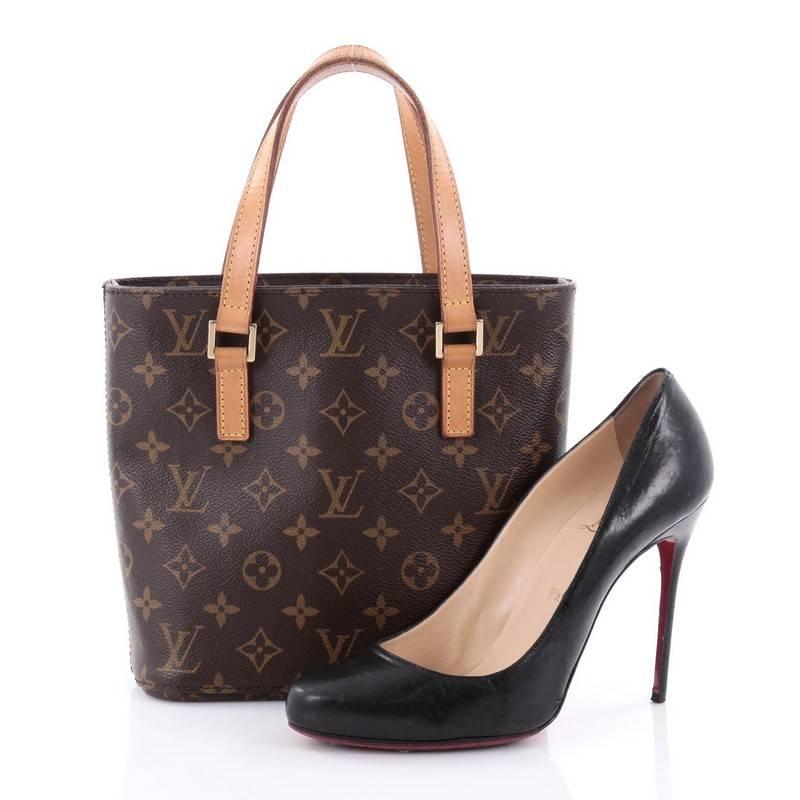 This authentic Louis Vuitton Vavin Handbag Monogram Canvas PM showcases a modern structure that makes it a perfect everyday tote. Constructed from Louis Vuitton's iconic brown monogram coated canvas, this petite tote features dual vachetta leather