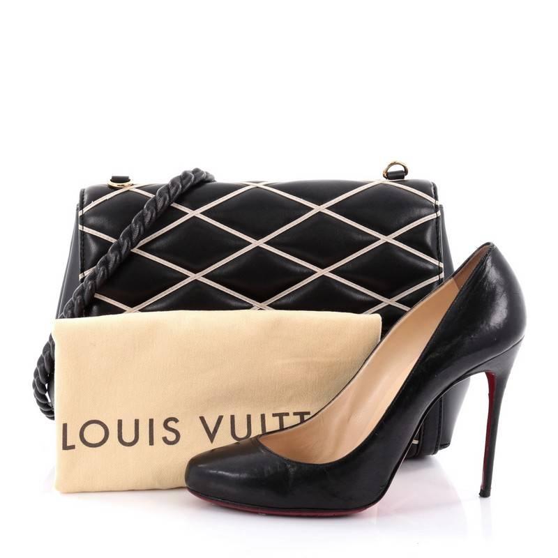 This authentic Louis Vuitton Pochette Flap Malletage Leather from the brand's Fall/Winter 2014 Runway Collection pays homage to Louis Vuitton's rich history of travel. Crafted from black and white quilted malletage lambskin leather, this elegant bag