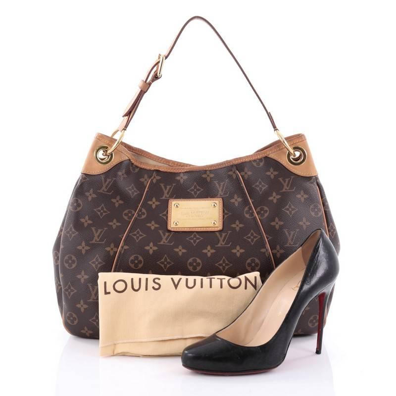 This authentic Louis Vuitton Galliera Handbag Monogram Canvas PM is as practical as it is iconic. Constructed from brown monogram coated canvas, this bag features adjustable shoulder strap, cowhide leather trims, metal logo plate accent, protective