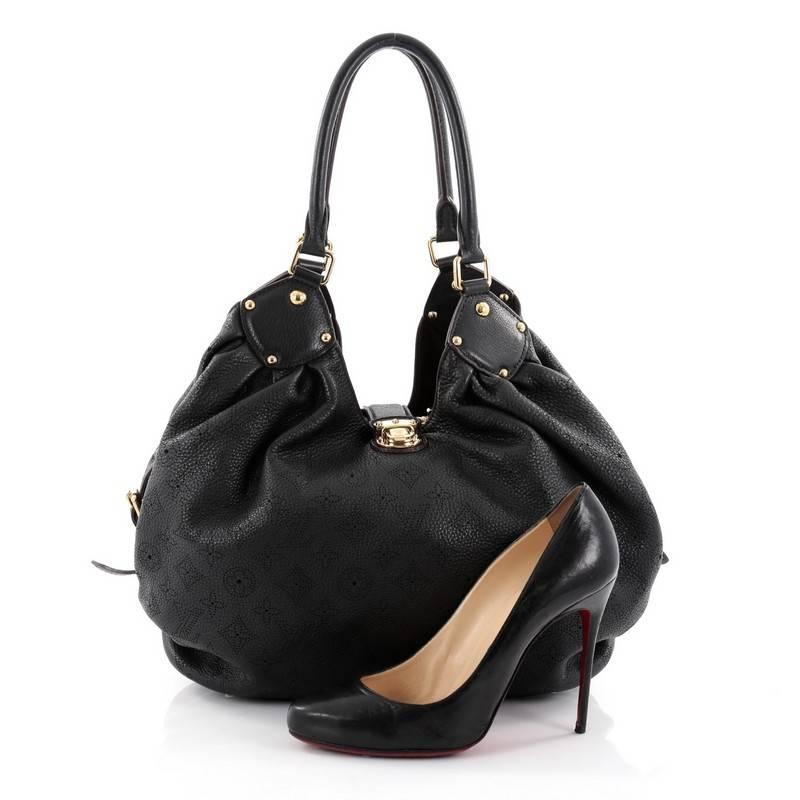 This authentic Louis Vuitton L Hobo Mahina Leather is sleek and refined in design apt for the modern woman. Crafted in the brand's black mahina leather, this feminine hobo features dual-rolled handles, buckle and stud details, protective base studs,