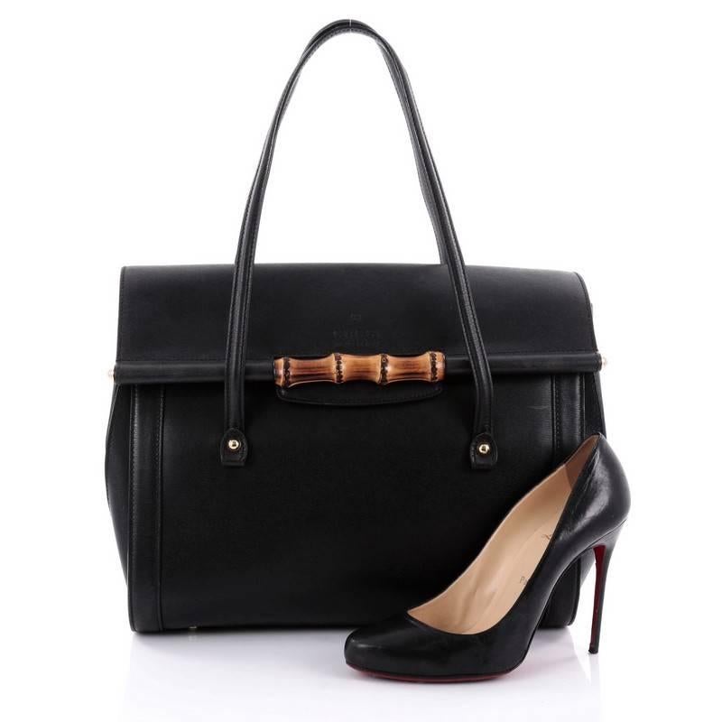 This authentic Gucci New Bullet Bamboo Top Handle Bag Leather Large is a gorgeous and chic bag perfect for the modern fashionista. Crafted from black leather, this bag features dual leather shoulder straps, Guardolo construction for the drop shape,