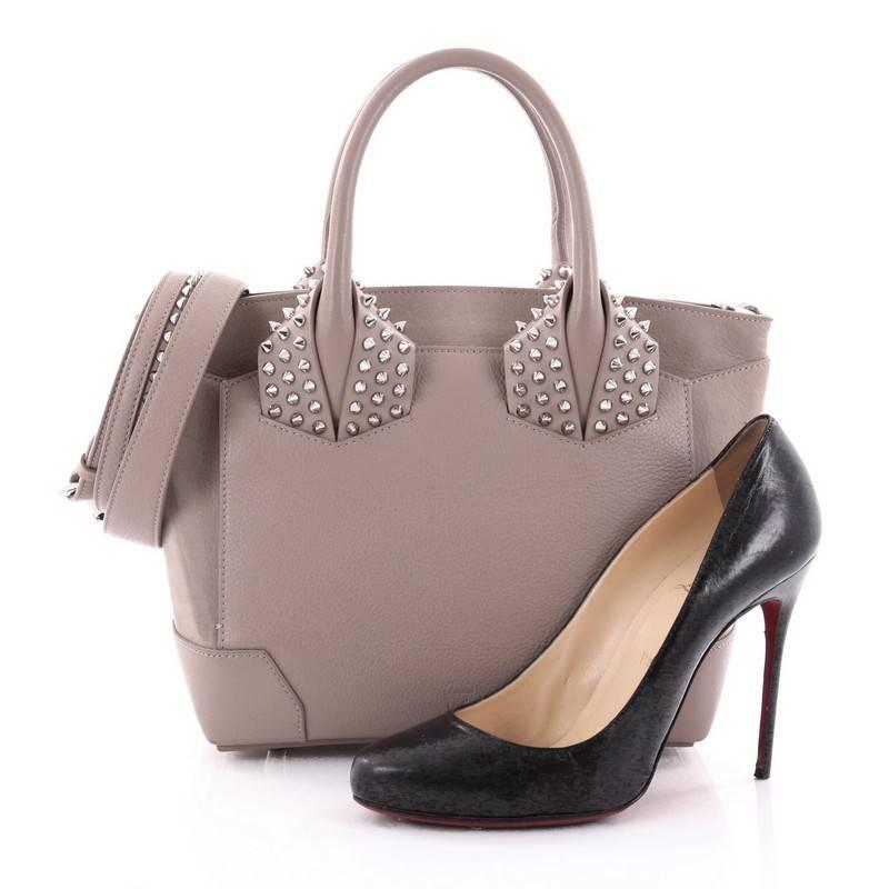 This authentic Christian Louboutin Eloise Satchel Spiked Leather Small exudes a modern style with an edgy twist. Crafted from taupe leather, this stand-out everyday tote features dual-rolled top handle with, silver-tone spike embellishments at base,