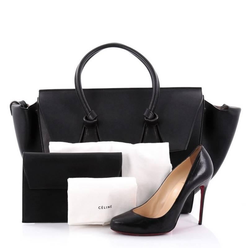 This authentic Celine Tie Knot Tote Smooth Leather Large is an absolute must-have for serious fashionistas. Crafted from black smooth leather, this boxy, chic tote features dual-rolled leather handles with signature knot accents, subtle stamped gold