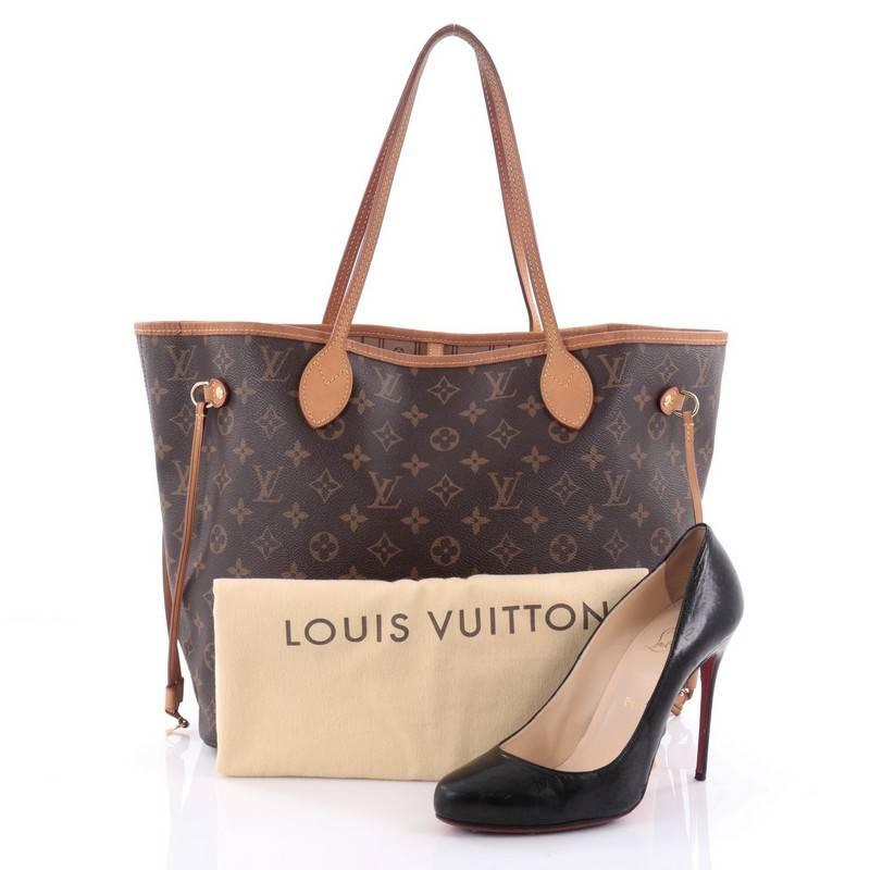 This authentic Louis Vuitton Neverfull Tote Monogram Canvas MM is a popular and practical oversized tote beloved by many. Constructed with Louis Vuitton's signature brown monogram coated canvas, this tote features dual slim vachetta leather handles,