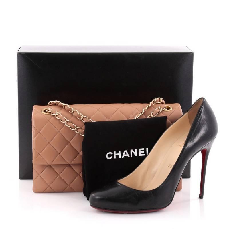 This authentic Chanel Envelope Lock 3 Bag Quilted Lambskin Small exudes a timeless style made for all occasions. Crafted in dust rose lambskin leather with Chanel's signature diamond quilting design, this elegant flap features woven-in leather chain