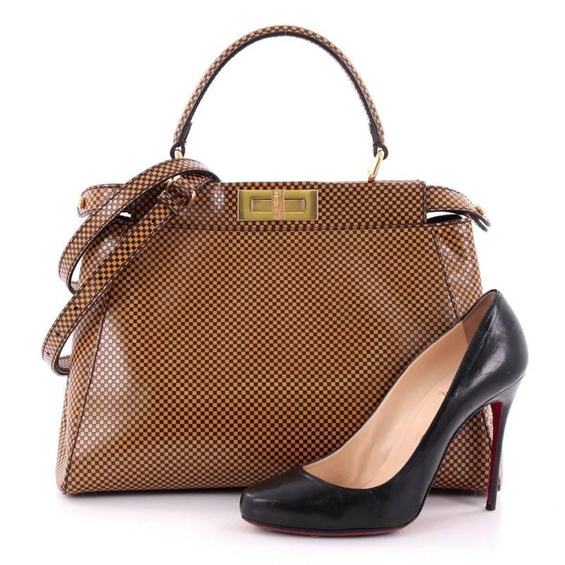 This authentic Fendi Peekaboo Handbag Check Print Leather Regular exudes a luxurious yet minimalist appearance. Crafted in tan and brown check leather, this versatile and stylish satchel features flat leather top handle, protective base studs and