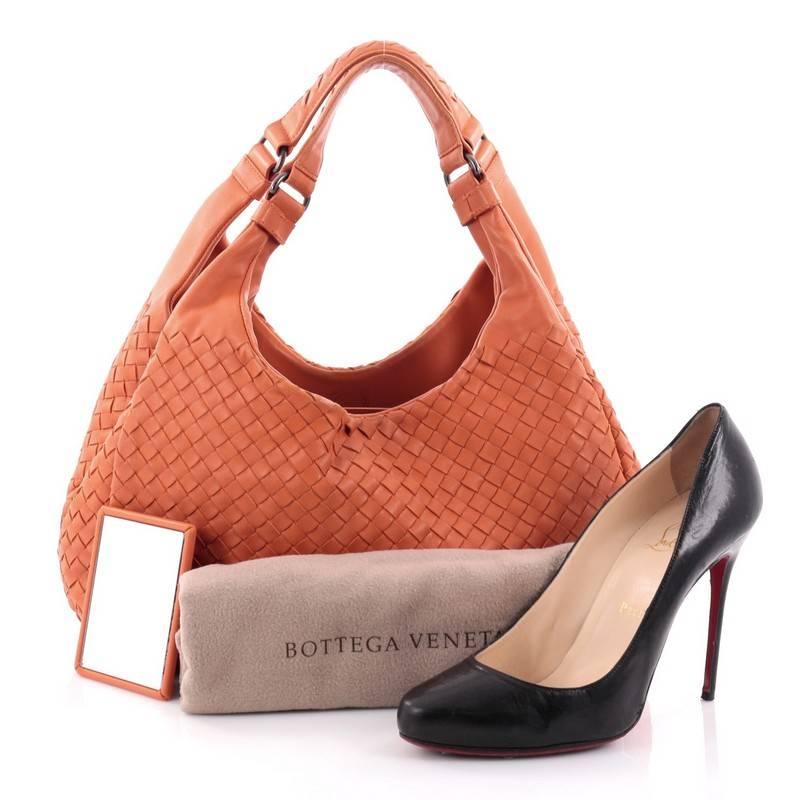 This authentic Bottega Veneta Campana Hobo Intrecciato Nappa Small is both understated yet elegant perfect for the modern woman. Crafted in Bottega Veneta's signature intrecciato woven orange nappa leather, this functional shoulder bag features dual
