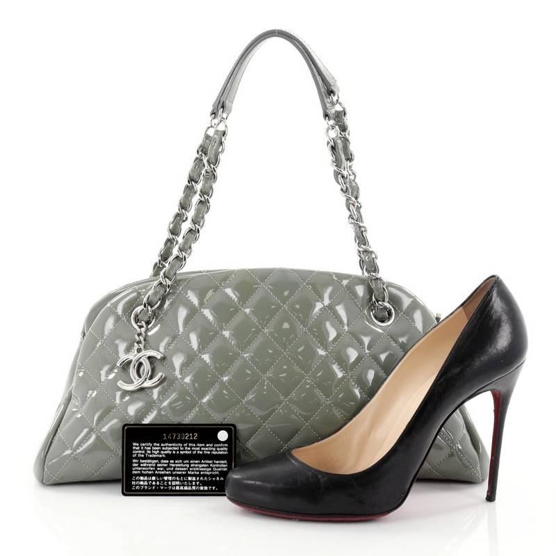 This authentic Chanel Just Mademoiselle Handbag Quilted Patent Medium showcases a sleek style that complements any look. Crafted from green patent leather in Chanel's iconic diamond quilt pattern, this bag features woven-in leather chain straps with