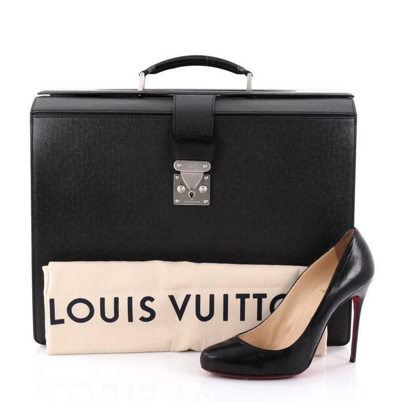 This authentic Louis Vuitton Pilot Briefcase Taiga Leather is a classic yet functional briefcase made for work or daily excursions. Crafted in black taiga leather, this briefcase features leather top handle, exterior back pocket, dual interior wall