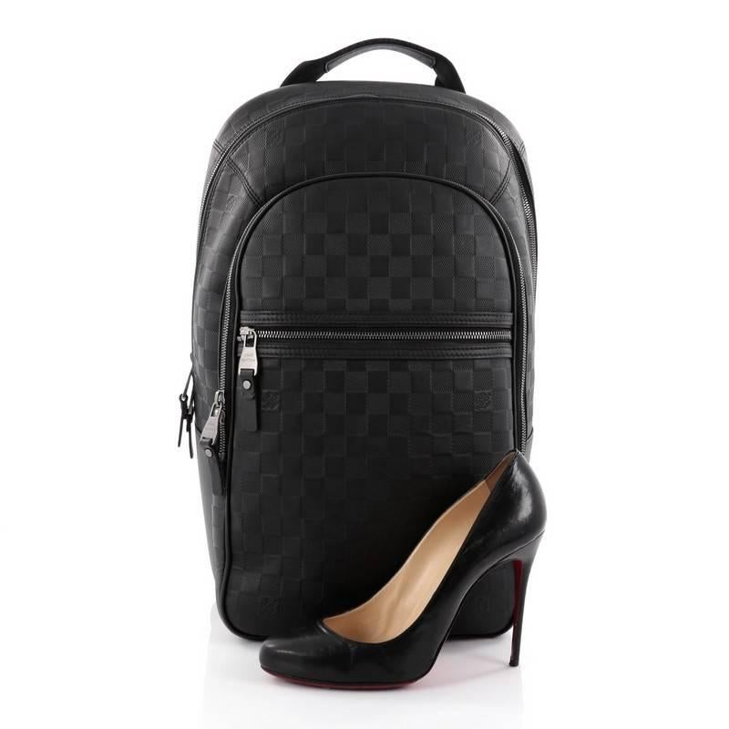 This authentic Louis Vuitton Michael NM Backpack Damier Infini Leather is a lightweight, luxe backpack combining style and comfort. Crafted from black damier infini leather, this chic, hands-free backpack features a short flat leather top handle,