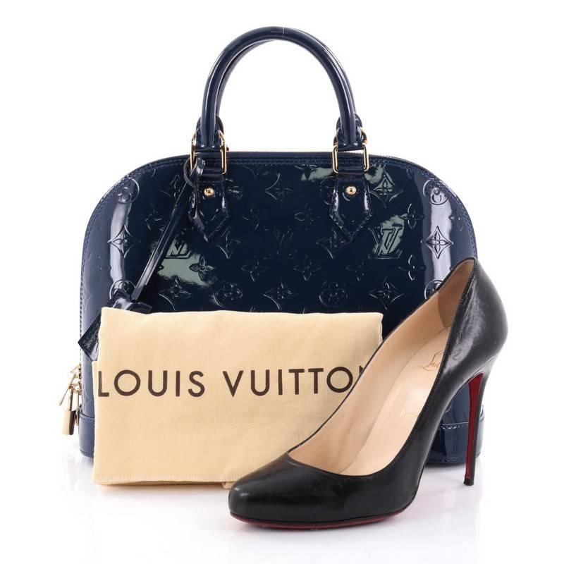 This authentic Louis Vuitton Alma Handbag Monogram Vernis PM is a fresh and elegant spin on a classic style that is perfect for all seasons. Crafted from Louis Vuitton's blue monogram vernis leather, this dome-shaped satchel features dual-rolled