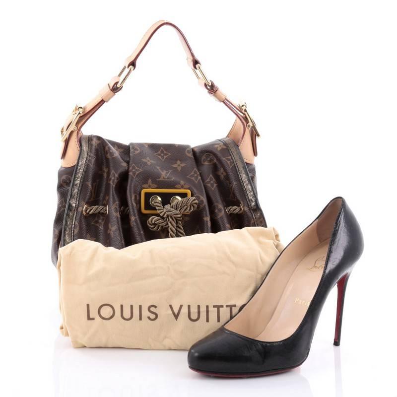 This authentic Louis Vuitton Kalahari Handbag Monogram Canvas PM presented in the brand's Spring/Summer 2009 Collection aptly named after the beautiful sub-saharan african desert mixes traditional styling with luxurious ethnic motif. Crafted in