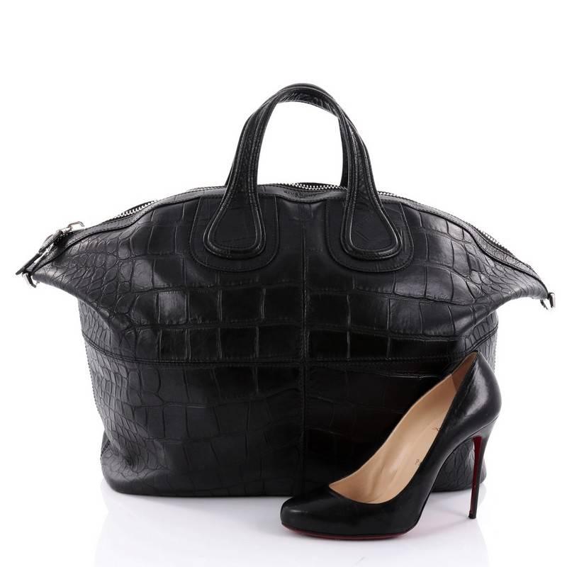 This authentic Givenchy Nightingale Satchel Crocodile Embossed Leather XL is a stylish and functional carry-all fit for all needs. Constructed in black crocodile embossed leather, this satchel is defined by its stitched quarters, dual leather