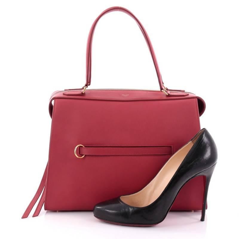 This authentic Celine Ring Bag Leather Small, presented in the brand's Spring 2015 Collection, mixes clean sophistication with understated functionality. Designed in red leather, this subdued satchel features a soft-structured silhouette, tall