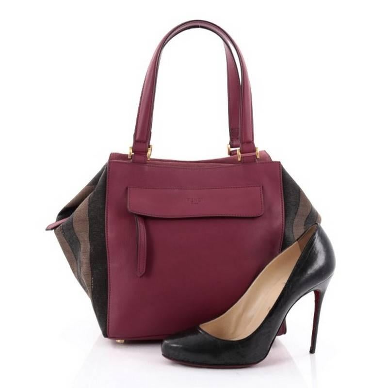 This authentic Fendi Boxy Tote Leather with Pequin Striped Canvas Large is a chic and practical bag that makes a perfect everyday carryall. Crafted from berry purple leather with brown pequin stripe canvas side panels, this boxy bag features