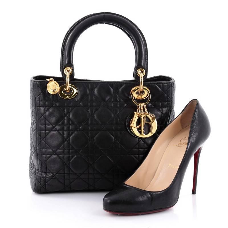 This authentic Christian Dior Vintage Lady Dior Handbag Cannage Quilt Lambskin Medium is an elegant classic bag that every fashionista needs in her wardrobe. Crafted from black lambskin leather in Dior's iconic cannage quilting, this boxy bag