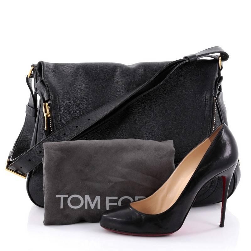 This authentic Tom Ford Jennifer Crossbody Bag Leather Large redefines modern luxury with timeless elegance. Crafted in black pebbled leather, this signature saddle shoulder bag features an adjustable crossbody strap, zip-top fold-over flap,