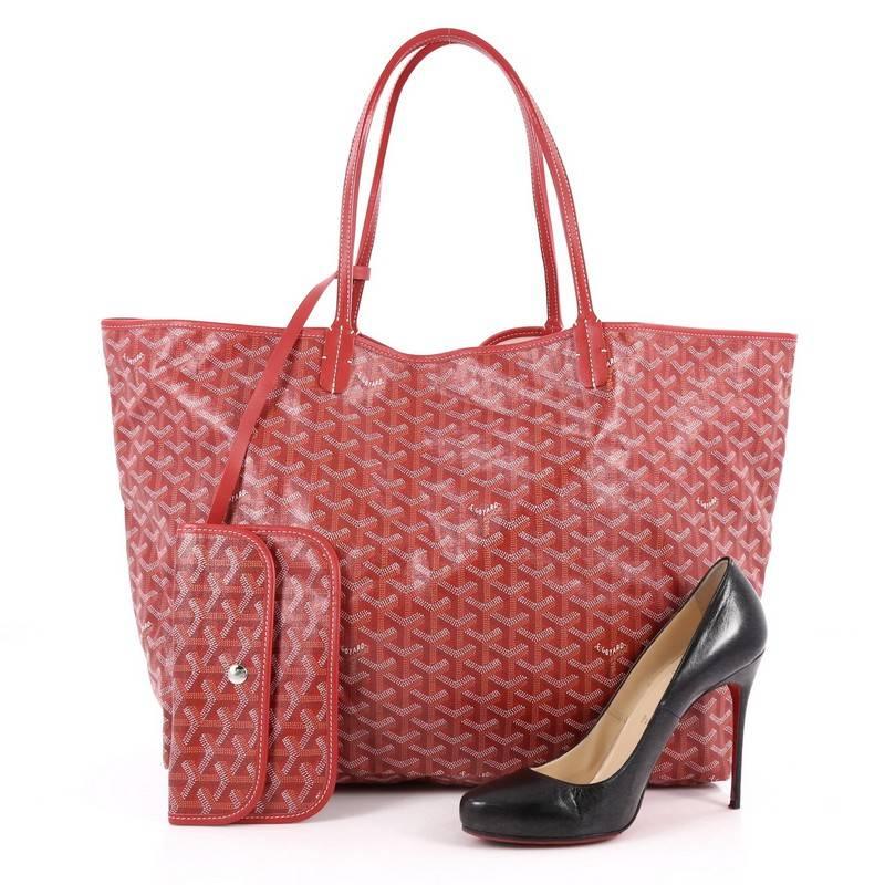 This authentic Goyard St. Louis Tote Coated Canvas GM showcases a modern style perfect for any on-the-go moments. Crafted from the popular and traditional red Goyard chevron printed canvas, this spacious tote features long, thin rolled leather top