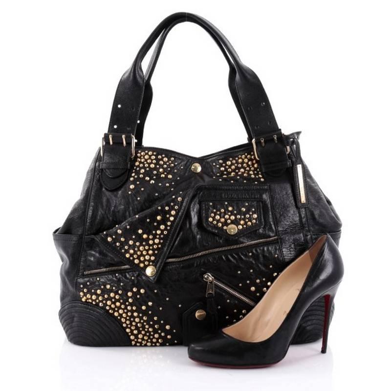 This authentic Alexander McQueen Faithful Tote Studded Leather Medium is full of non-symmetrical goodness that you can definitely appreciate. Crafted from black leather with gold stud detailing. This stylish edgy bag features dual leather handles,