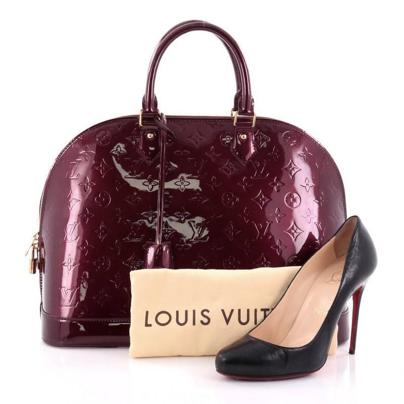 This authentic Louis Vuitton Alma Handbag Monogram Vernis GM is a fresh and elegant spin on a classic style that is perfect for all seasons. Crafted from Louis Vuitton's rouge fauviste monogram vernis leather, this dome-shaped satchel features