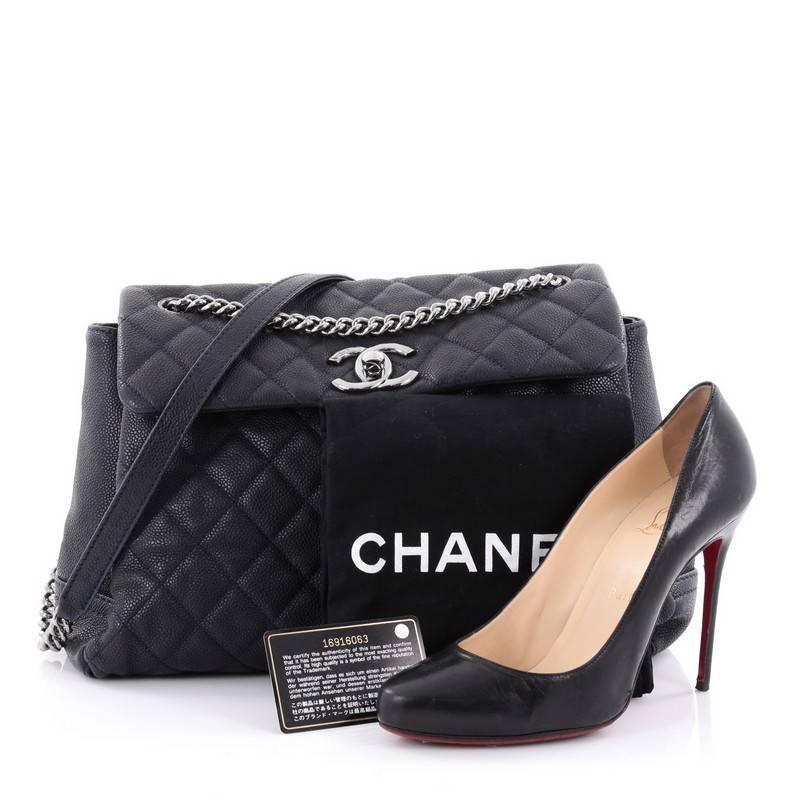 This authentic Chanel Lady Pearly Flap Bag Quilted Matte Caviar Large mixes easy-casual style with modern flair. Crafted in navy quilted matte caviar, this luxurious flap bag features Chanel's signature diamond quilting, polished chunky chains with