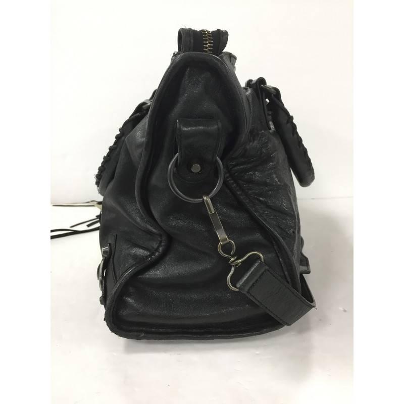 This authentic Balenciaga City Classic Studs Handbag Leather Medium is for any on-the-go fashionista. Constructed in black leather, this popular bag features dual braided woven handle straps, front zip pocket, iconic Balenciaga classic studs and