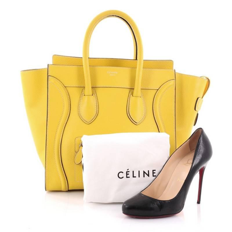 This authentic Celine Luggage Handbag Grainy Leather Mini epitomizes Phoebe Philo's minimalist yet chic style. Constructed in yellow grainy leather, this beloved fashionista's bag features dual-rolled leather handles, a frontal zip pocket, Celine's