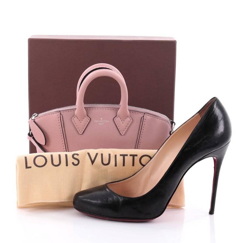This authentic Louis Vuitton Soft Lockit Handbag Leather Nano first introduced in the 1950's, is re-imagined with modern and understated, clean lines showcasing the brand's ever-evolving style. Crafted from magnolia dusty pink leather, this chic
