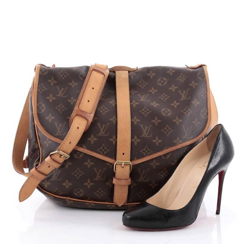 This authentic Louis Vuitton Saumur Handbag Monogram Canvas GM showcases the brand's reinterpretation of the classic saddle bag. Crafted in Louis Vuitton's popular brown monogram coated canvas, this bag features long adjustable shoulder strap,