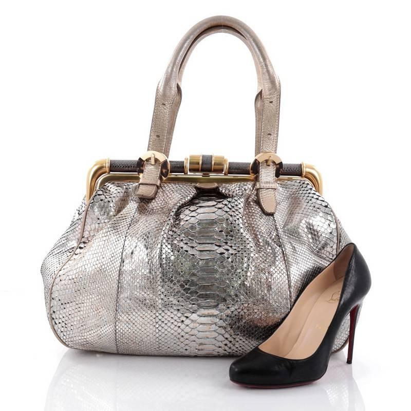 This authentic Oscar de la Renta Larrabee Doctor Bag Python is unique and luxurious in design ideal for modern woman. Crafted in genuine metallic gold and silver python skin, this bag features dual-rolled handles with belt and resin buckle details,