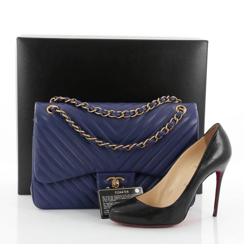 This authentic Chanel Classic Double Flap Bag Chevron Lambskin Jumbo presented in the brand's 2014 limited edition collection mixes classic luxury with cool-girl edge perfect for the modern woman. Crafted from bluish purple lambskin leather, this