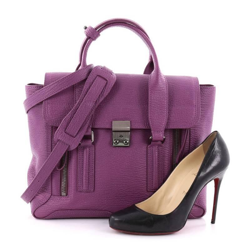 This authentic 3.1 Phillip Lim Pashli Satchel Leather Medium is a practical bag with a stylish edge made for on-the-go moments. Crafted from purple leather, this chic satchel features dual top handles, expandable zip sides, top flap push-lock