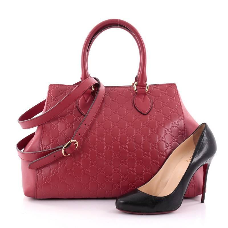This authentic Gucci Soft Signature Convertible Top Handle Bag Guccissima Leather Large is a fresh, casual-chic bag made for everyday excursions. Crafted from red guccissima leather, this no-fuss bag features dual-rolled leather handles, hidden side