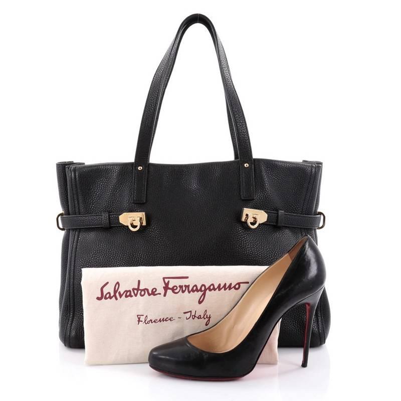 This authentic Salvatore Ferragamo Nencia Tote Leather East West is a casual yet chic tote perfect for travelling in style or everyday excursions. Crafted in black leather, this chic and simple bag features dual slim shoulder straps, belted straps