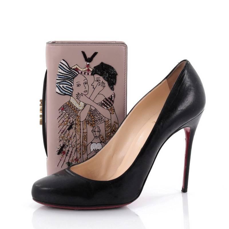 This authentic Christian Dior Tarot Pouch Embroidered Leather is from the brands' Spring/Summer 2017 Bag Collection, the first collection from Maria Grazia Chiuri which was presented during Paris Fashion Week. Crafted from light mauve leather with