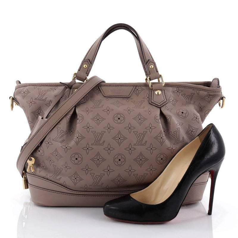 This authentic Louis Vuitton Stellar Handbag Mahina Leather PM displays understated simplicity and elegance with versatile functionality made for the modern woman. Crafted from taupe perforated mahina leather, this soft-structured tote features dual