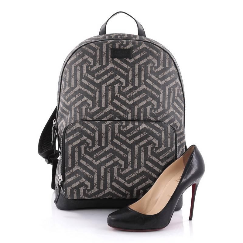 This authentic Gucci Zip Pocket Backpack Caleido Print GG Coated Canvas Medium is a stylish backpack that is suitable for school or light travel, with the designer appeal. Crafted in black and brown caleido print GG coated canvas, this bag features