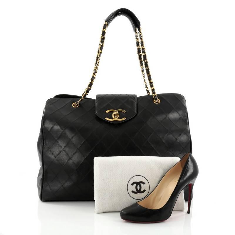 This authentic Chanel Vintage Supermodel Weekender Bag Quilted Leather Large is a hard-to-find, stylish solution to all your travel needs. Crafted in luxurious black quilted leather, this oversized, weekender bag features tall dual-leather strap