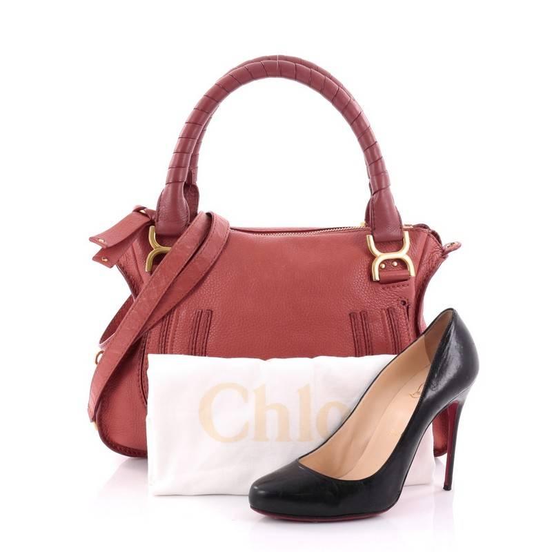 This authentic Chloe Marcie Satchel Leather Medium is perfect for the on-the-go fashionista. Constructed from red leather, this popular satchel features wrapped leather handles, horseshoe stitched front flap, and gold-tone hardware. Its top zipped